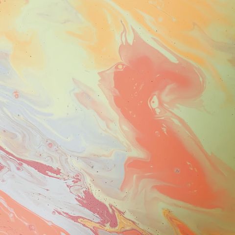 Abstract shape representing movement and flow on a peach background.